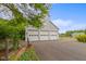 Detached three-car garage with stylish detailing and a well-maintained driveway at 14655 Little Eagle Creek Ave, Zionsville, IN 46077