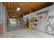 Bright horse stable featuring a well-maintained aisle, white walls, and wooden stalls at 14655 Little Eagle Creek Ave, Zionsville, IN 46077