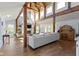 Spacious living room with wood beam vaulted ceiling, stone fireplace, and hardwood floors at 14655 Little Eagle Creek Ave, Zionsville, IN 46077
