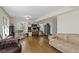Open living room featuring hardwood floors, multiple seating areas, and large windows at 14655 Little Eagle Creek Ave, Zionsville, IN 46077