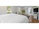 Bright bedroom with hardwood floors, armchair and ensuite bathroom access at 14655 Little Eagle Creek Ave, Zionsville, IN 46077