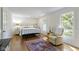 Bright bedroom with a metal bed frame, hardwood floors, an armchair and good natural light at 14655 Little Eagle Creek Ave, Zionsville, IN 46077