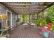 Inviting patio features wood pergola, cozy seating, and charming outdoor decor at 14655 Little Eagle Creek Ave, Zionsville, IN 46077