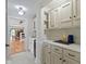 Hallway wet bar with white cabinets and hardware leading to a full living area at 14655 Little Eagle Creek Ave, Zionsville, IN 46077