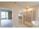 This bathroom showcases a walk-in shower, soaking tub, and entrance to the walk-in closet at 16156 Oliver St, Fishers, IN 46037