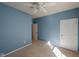 Empty blue bedroom with ceiling fan, neutral carpeting and a closet with a door at 16156 Oliver St, Fishers, IN 46037