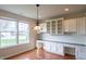 Sun-filled dining area with custom cabinetry, sleek countertops, and views of the outdoors at 16156 Oliver St, Fishers, IN 46037