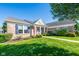 Lovely brick home showcasing a green lawn, blue shutters, and a striking red front door at 16156 Oliver St, Fishers, IN 46037