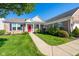 Well-maintained brick home boasting a beautifully landscaped front yard with a welcoming red front door at 16156 Oliver St, Fishers, IN 46037
