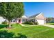 Charming brick home featuring a manicured front yard with lush lawn and a vibrant red front door at 16156 Oliver St, Fishers, IN 46037