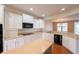 Bright kitchen with white cabinets, a center island, and black appliances for a modern feel at 16156 Oliver St, Fishers, IN 46037