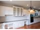 Stylish kitchen area featuring custom white cabinets with hardwood floors and work space at 16156 Oliver St, Fishers, IN 46037
