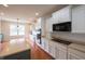 Bright kitchen with an island, modern appliances, white cabinets, and hardwood flooring at 16156 Oliver St, Fishers, IN 46037