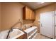 A spacious laundry room with a sink, cabinets, and ample counter space and storage at 16156 Oliver St, Fishers, IN 46037