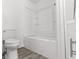Bright bathroom featuring a toilet and a bathtub with a shower, creating a clean and functional space at 1630 N Granville N Ave, Muncie, IN 47303