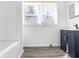 Modern bathroom featuring a dark vanity, crisp white walls, and a window for great natural light at 1630 N Granville N Ave, Muncie, IN 47303