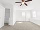 Spacious bedroom with neutral carpet, ceiling fan and natural light offering a comfortable and inviting atmosphere at 1630 N Granville N Ave, Muncie, IN 47303
