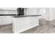 Kitchen island features modern white cabinets with black countertops at 1630 N Granville N Ave, Muncie, IN 47303