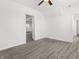 Inviting room with gray laminate flooring, white walls, ceiling fan, and bright natural light at 1630 N Granville N Ave, Muncie, IN 47303