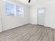 Bright, airy room featuring stylish gray laminate flooring, crisp white walls, and a door to the exterior at 1630 N Granville N Ave, Muncie, IN 47303