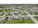 Community aerial view featuring a pond, green spaces, well-maintained lawns, and attractive homes, providing a desirable living environment at 16305 Kenora N Ln, Fortville, IN 46040