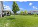 Beautiful backyard featuring a covered patio, mature trees, and manicured lawn at 16305 Kenora N Ln, Fortville, IN 46040