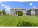 Lush backyard with well-maintained lawn, mature trees, and exterior view of the home at 16305 Kenora N Ln, Fortville, IN 46040