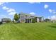 Expansive backyard featuring lush green lawn, mature trees, and neighborhood views at 16305 Kenora N Ln, Fortville, IN 46040