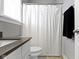 Bathroom with white shower curtain, toilet, and vanity featuring white cabinets at 16305 Kenora N Ln, Fortville, IN 46040