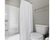Bathroom featuring a white tub, shower, toilet, and white shower curtain at 16305 Kenora N Ln, Fortville, IN 46040