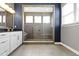 This elegant bathroom features sleek fixtures, a stone shower, and an abundance of natural light at 16305 Kenora N Ln, Fortville, IN 46040