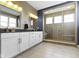 This stunning bathroom has a double vanity, modern fixtures, and a walk-in shower at 16305 Kenora N Ln, Fortville, IN 46040