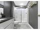 Bathroom featuring a walk-in shower with glass doors, a sleek vanity, and modern fixtures at 16305 Kenora N Ln, Fortville, IN 46040