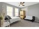 Bright bedroom featuring two large windows, neutral walls, carpet, and a ceiling fan at 16305 Kenora N Ln, Fortville, IN 46040