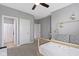 Bedroom featuring neutral walls, carpet, and doorways leading to a bathroom and other rooms at 16305 Kenora N Ln, Fortville, IN 46040