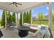 Cozy covered patio area featuring comfortable seating, a fire pit, and serene outdoor views at 16305 Kenora N Ln, Fortville, IN 46040