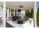 Inviting covered patio with comfortable seating, a fire pit, and views of the lush backyard at 16305 Kenora N Ln, Fortville, IN 46040