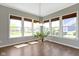 Bright dining area featuring large windows with views of the landscaped yard and a modern chandelier at 16305 Kenora N Ln, Fortville, IN 46040