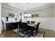 Charming dining room with a large table, elegant lighting, and a wine rack for entertaining guests at 16305 Kenora N Ln, Fortville, IN 46040