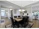 Spacious dining room showcasing stylish lighting fixtures and views to the kitchen at 16305 Kenora N Ln, Fortville, IN 46040