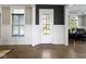 Entryway featuring hardwood floors, white wainscoting, and view through the glass front door at 16305 Kenora N Ln, Fortville, IN 46040