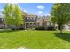 Beautiful two-story brick home with a lush lawn and mature trees on a sunny day at 16305 Kenora N Ln, Fortville, IN 46040