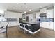 Spacious gourmet kitchen with white cabinets, a kitchen island, and stainless steel appliances at 16305 Kenora N Ln, Fortville, IN 46040