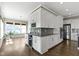 Gourmet kitchen with white cabinetry, stainless steel appliances, wine storage and island seating at 16305 Kenora N Ln, Fortville, IN 46040
