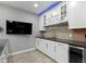 Basement kitchenette with white cabinets, dark countertops and stainless beverage cooler at 16305 Kenora N Ln, Fortville, IN 46040