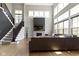 Bright living room featuring a two-story ceiling, fireplace, dark accent wall and a staircase at 16305 Kenora N Ln, Fortville, IN 46040