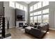 Bright living room features a fireplace, large windows and a comfortable sectional sofa at 16305 Kenora N Ln, Fortville, IN 46040