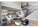 Open concept living area with a staircase and open view into the kitchen and dining area at 16305 Kenora N Ln, Fortville, IN 46040