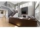 Spacious living room with a fireplace, large windows, and a view of the staircase and second floor at 16305 Kenora N Ln, Fortville, IN 46040