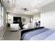 Bright primary suite features a bed, seating, workspace, and a tray ceiling at 16305 Kenora N Ln, Fortville, IN 46040